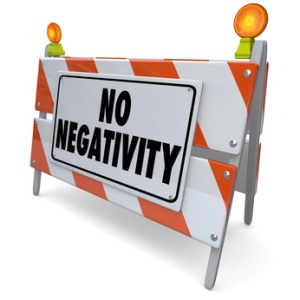Eliminate negativity!!! No Negativity words on a road construction barrier or sign to illustrate that only positive attitudes, good moods and outlooks are allowed.